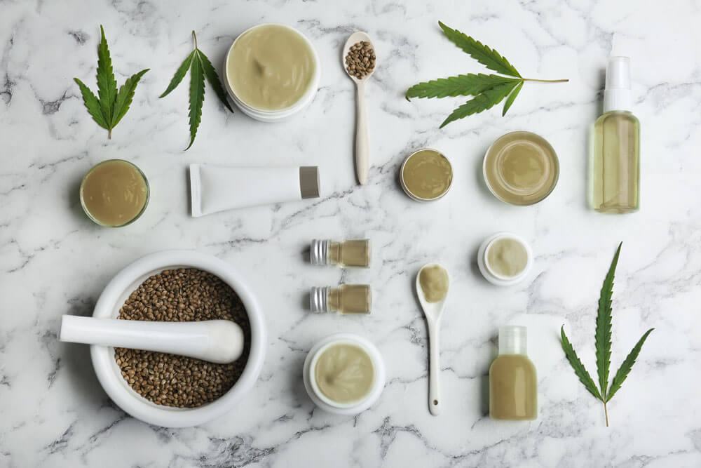 Flat lay composition with hemp lotion on marble background